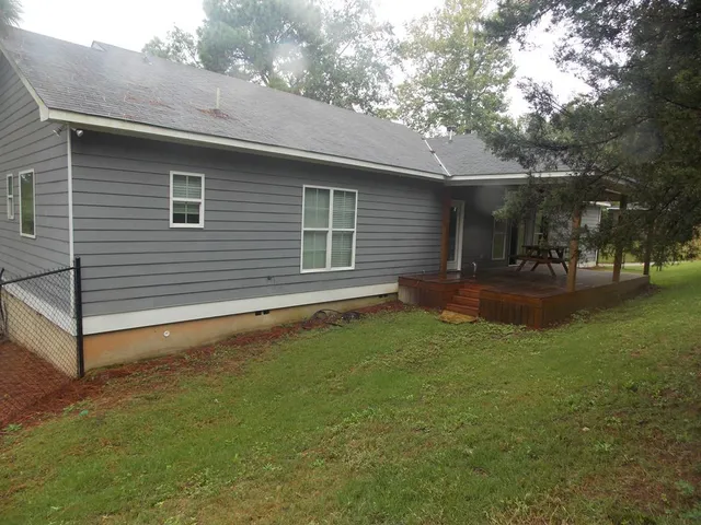 a backyard of a house with table and chairs