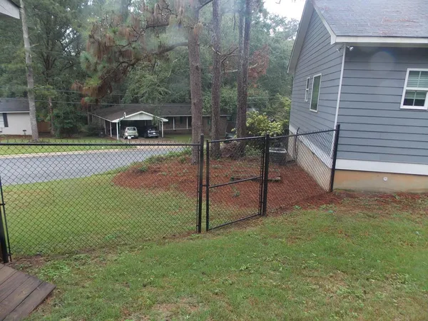 a view of a house with backyard and sitting area