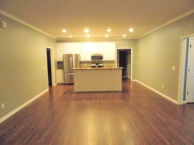 a view of a kitchen with a sink and a refrigerator