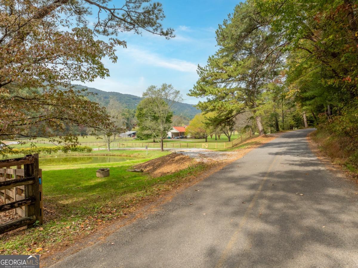 2673 Tails Creek Church Road Ellijay, GA 30540 - Photo 3 of 23 a view of an ocean with a huge green field and covered with trees