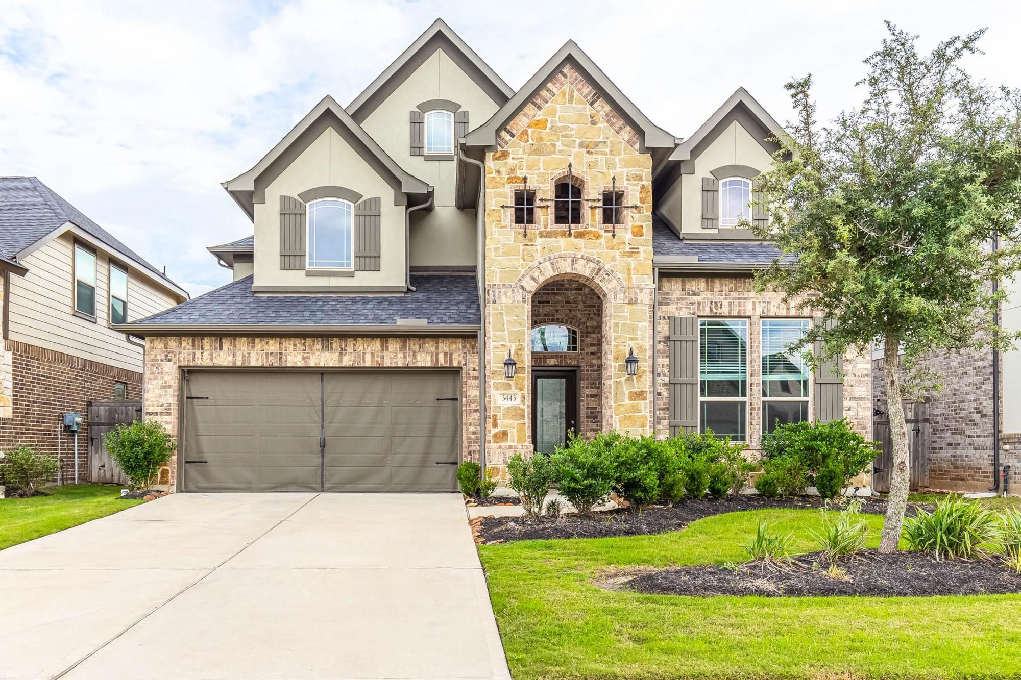a front view of a house with a yard and garage