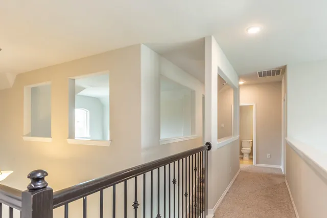 a view of a hallway with entryway to a windows