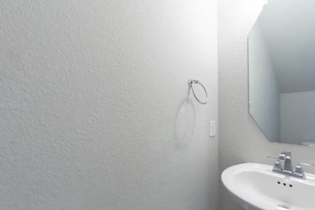 a bathroom with a sink and mirror
