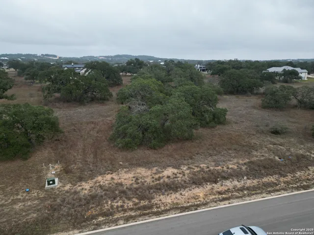 an aerial view of a house with a yard