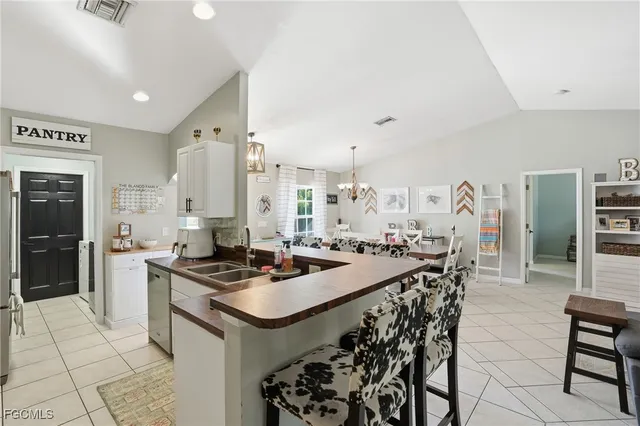 a kitchen with sink and refrigerator