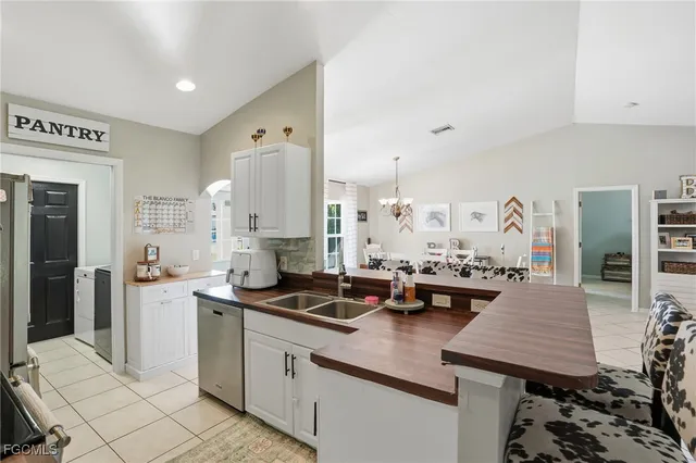 a kitchen with granite countertop a sink stove and cabinets
