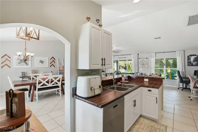 a kitchen with a sink a stove and cabinets
