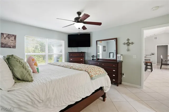 a bedroom with bed and wooden floor
