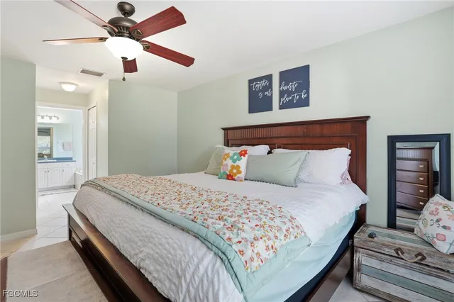 a bathroom with a granite countertop sink mirror and a bathtub