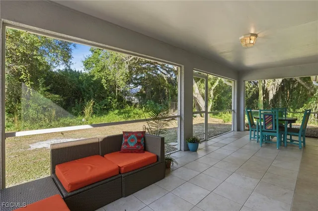 a view of a chairs and table in the balcony