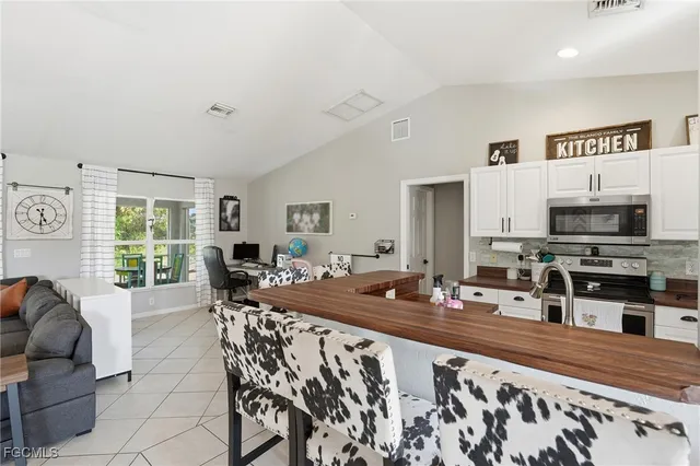 a living room with furniture a flat screen tv and a large window