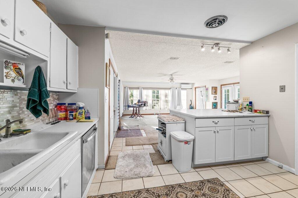 1226 Halifax Road Jacksonville, FL 32216 - Photo 11 of 29 a room with kitchen island a sink a stove and cabinets