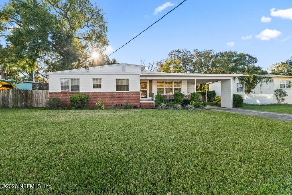 1226 Halifax Road Jacksonville, FL 32216 - Photo 28 of 29 a front view of house with yard and green space
