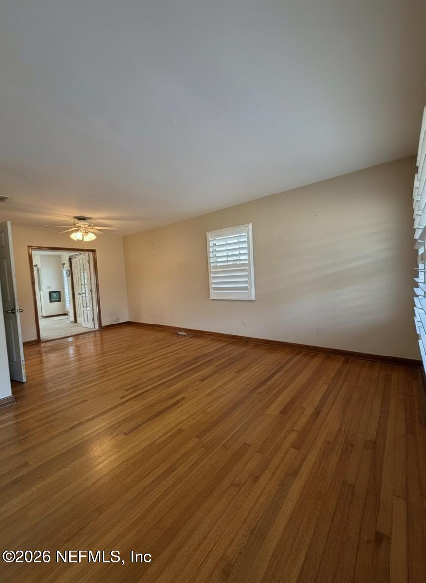 1226 Halifax Road Jacksonville, FL 32216 - Photo 3 of 29 a view of an empty room with wooden floor and a window