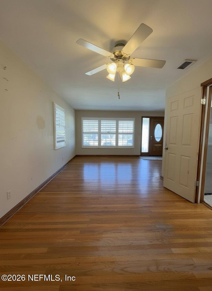 1226 Halifax Road Jacksonville, FL 32216 - Photo 4 of 29 a view of empty room with wooden floor and fan