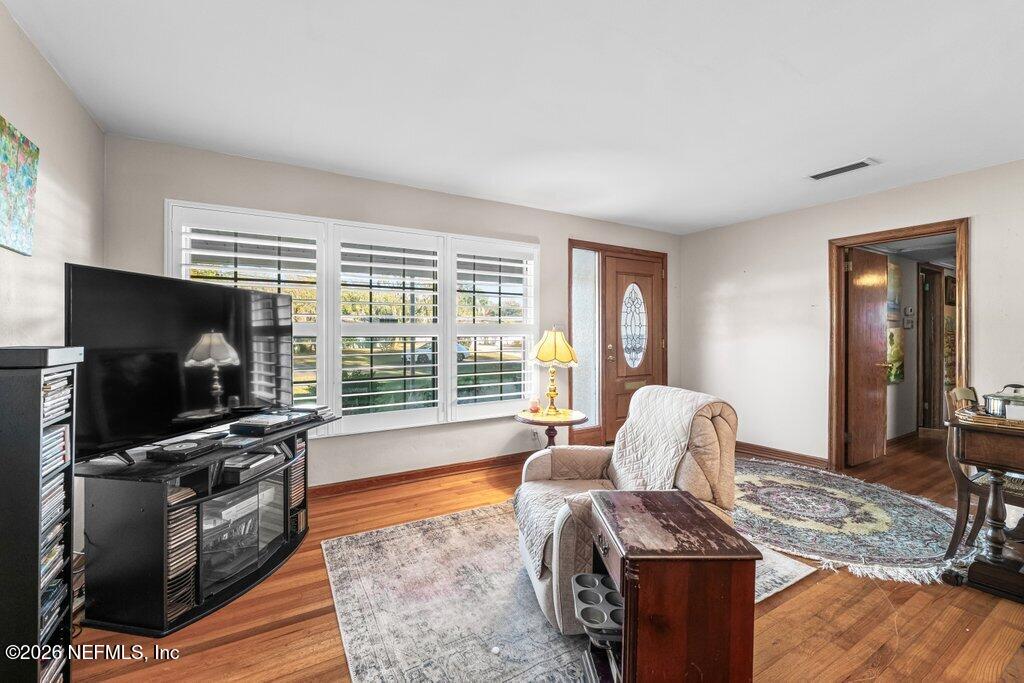 1226 Halifax Road Jacksonville, FL 32216 - Photo 7 of 27 a living room with furniture and a flat screen tv