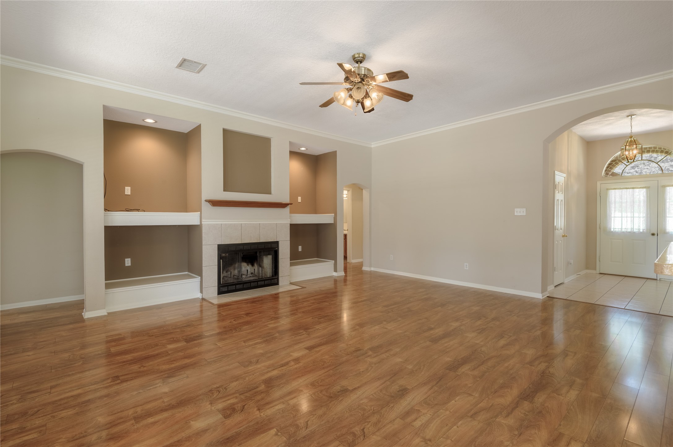 324 Red Oak Lane Trinity, TX 75862 - Photo 17 of 49 a view of a livingroom with a fireplace a chandelier and wooden floor