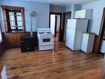 a kitchen with a refrigerator and a stove