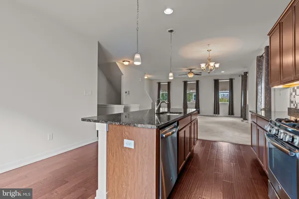 a kitchen with stainless steel appliances granite countertop a stove and a large cabinets
