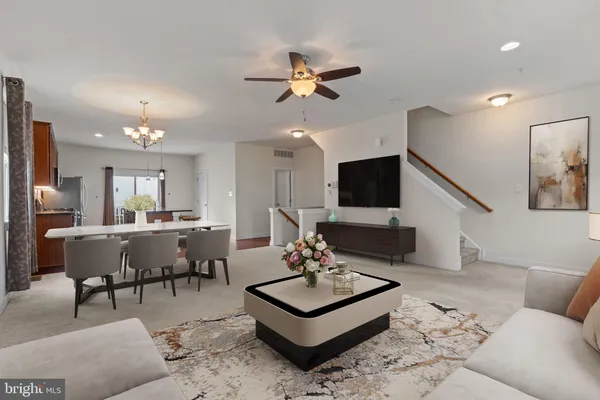 a living room with furniture a rug and a flat screen tv