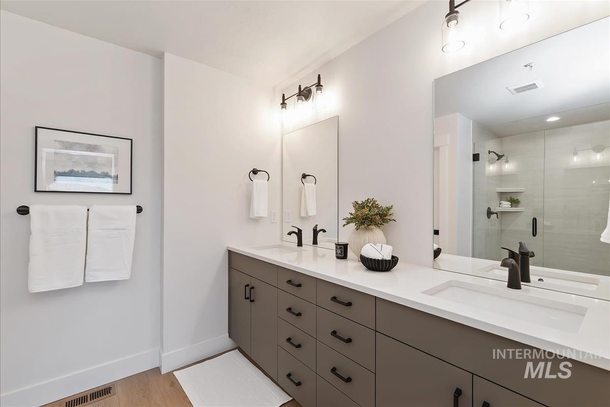 1703 South Federal Way Boise, ID 83705 - Photo 19 of 38 Bathroom featuring double vanity, a shower stall, and light wood-style floors
