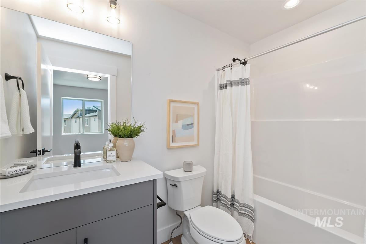 1703 South Federal Way Boise, ID 83705 - Photo 27 of 38 Bathroom featuring vanity and shower / tub combo with curtain