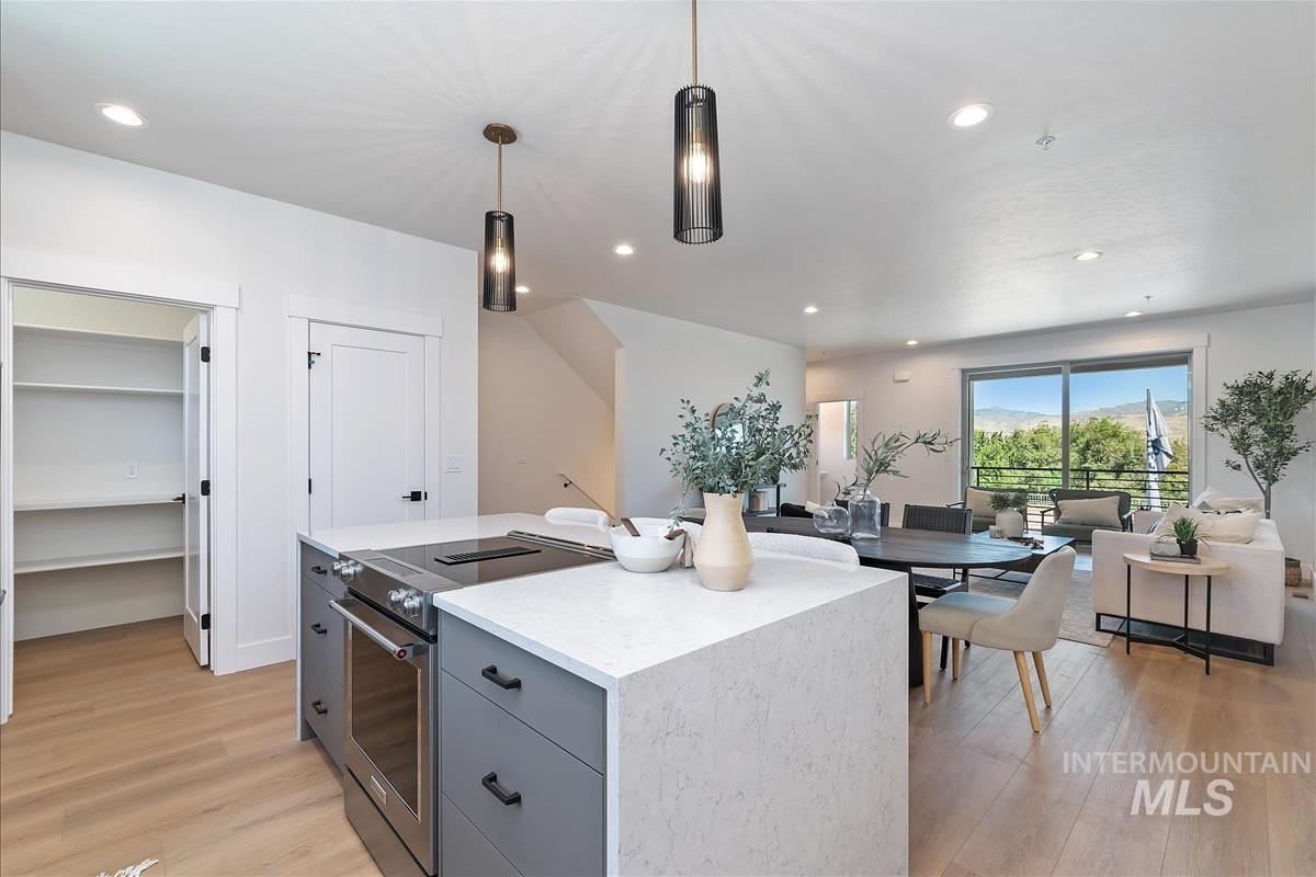 1703 South Federal Way Boise, ID 83705 - Photo 38 of 38 Kitchen with electric stove, gray cabinetry, light wood-type flooring, open floor plan, and decorative light fixtures