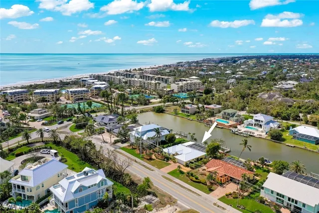 an aerial view of a city with lots of residential buildings lake and ocean view