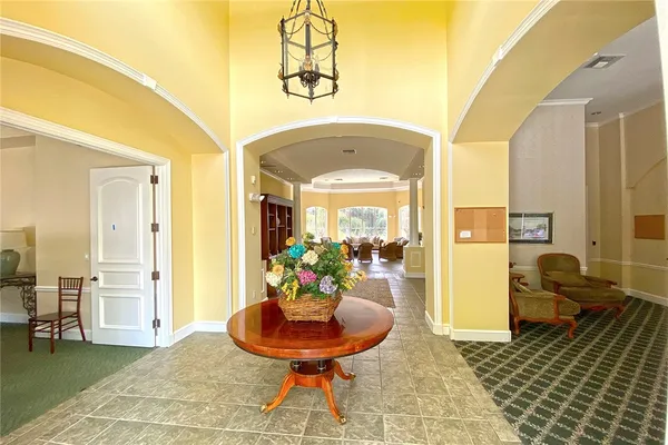 a living room with furniture and a chandelier