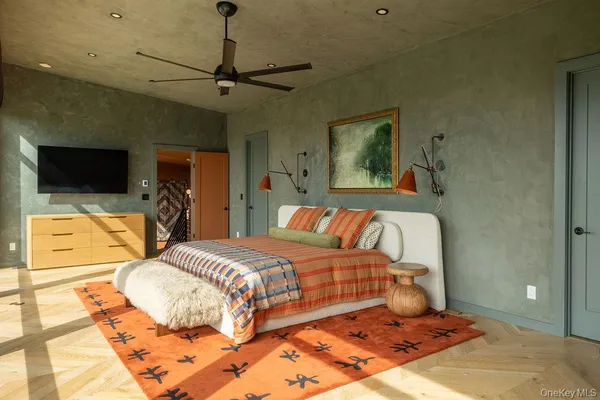 a bedroom with a bed and glass door