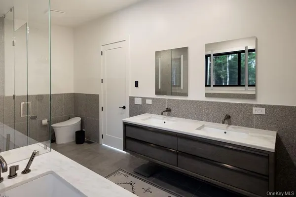 a bathroom with a double vanity sink and a mirror