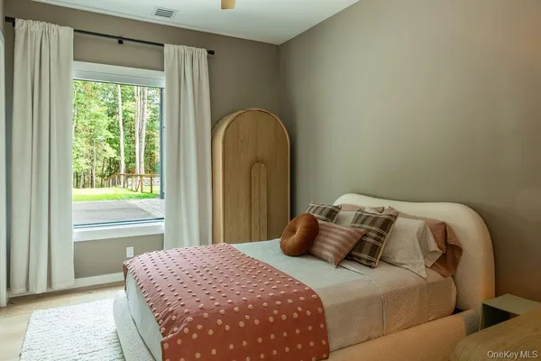 a bedroom with a bed and a window