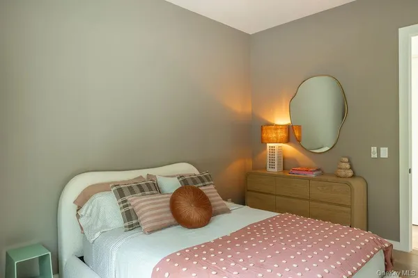 a bedroom with a bed and a mirror