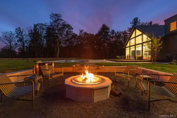 a swimming pool with outdoor seating and yard