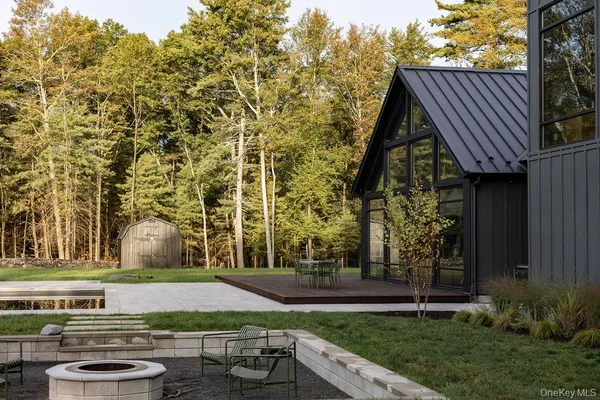 a view of house with outdoor space and sitting area