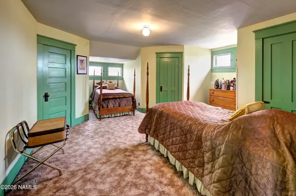 a kitchen with a sink stainless steel appliances furniture cabinets and a window