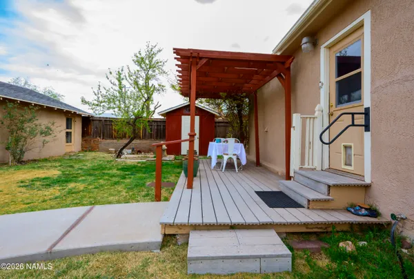 a backyard of a house with yard fire pit and chairs