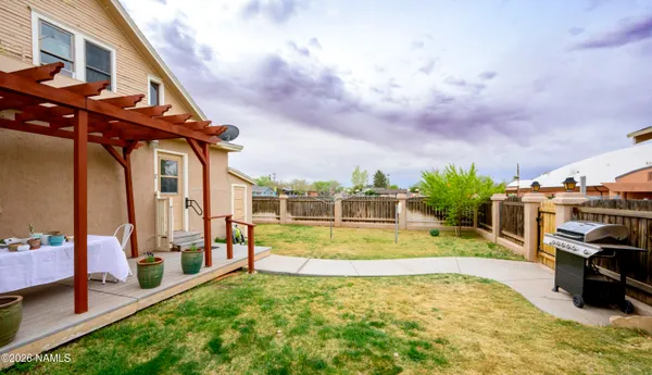 a view of a table and chairs in backyard of the house
