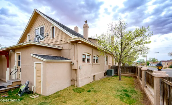 a view of a house with wooden fence