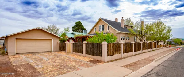 a view of a house with wooden fence