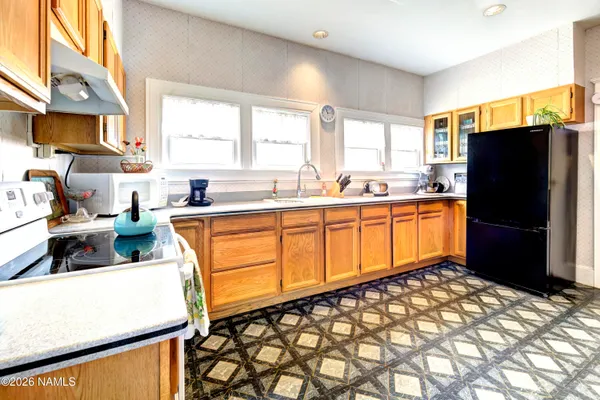 a kitchen with sink cabinets and dining table