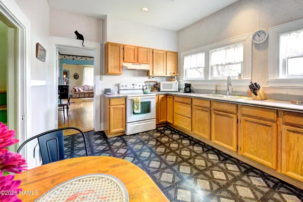 a living room with furniture a window and a chandelier