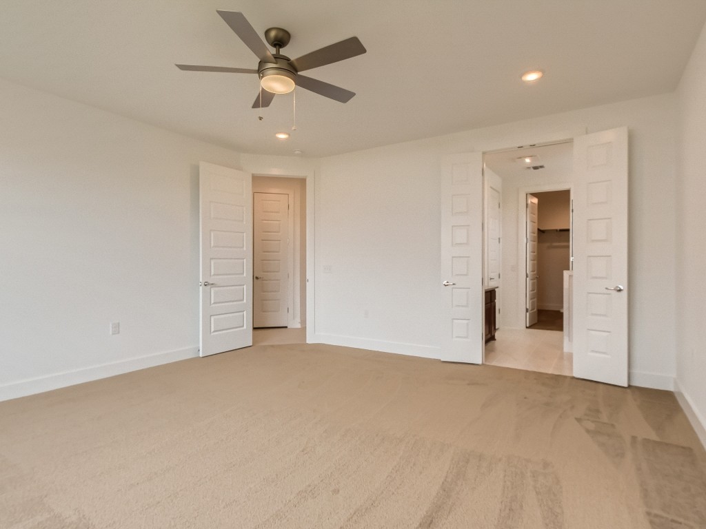 9101 Spire View Austin, TX 78744 - Photo 16 of 29 an empty room with closet and a ceiling fan
