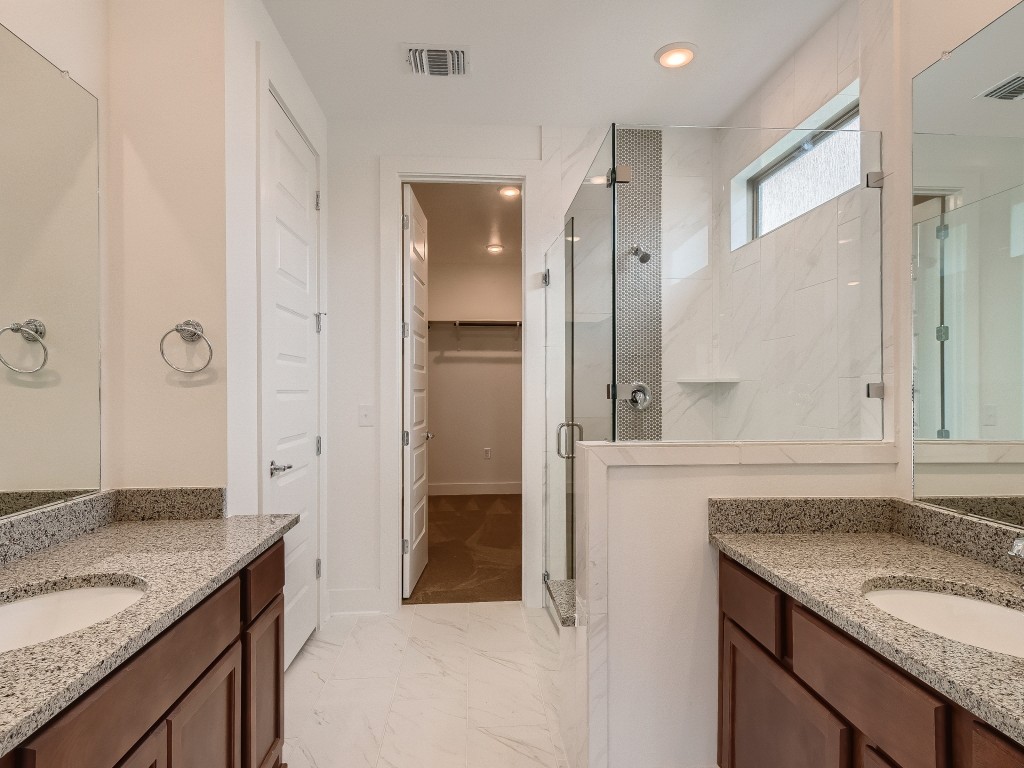 9101 Spire View Austin, TX 78744 - Photo 17 of 29 a bathroom with a granite countertop sink and a mirror