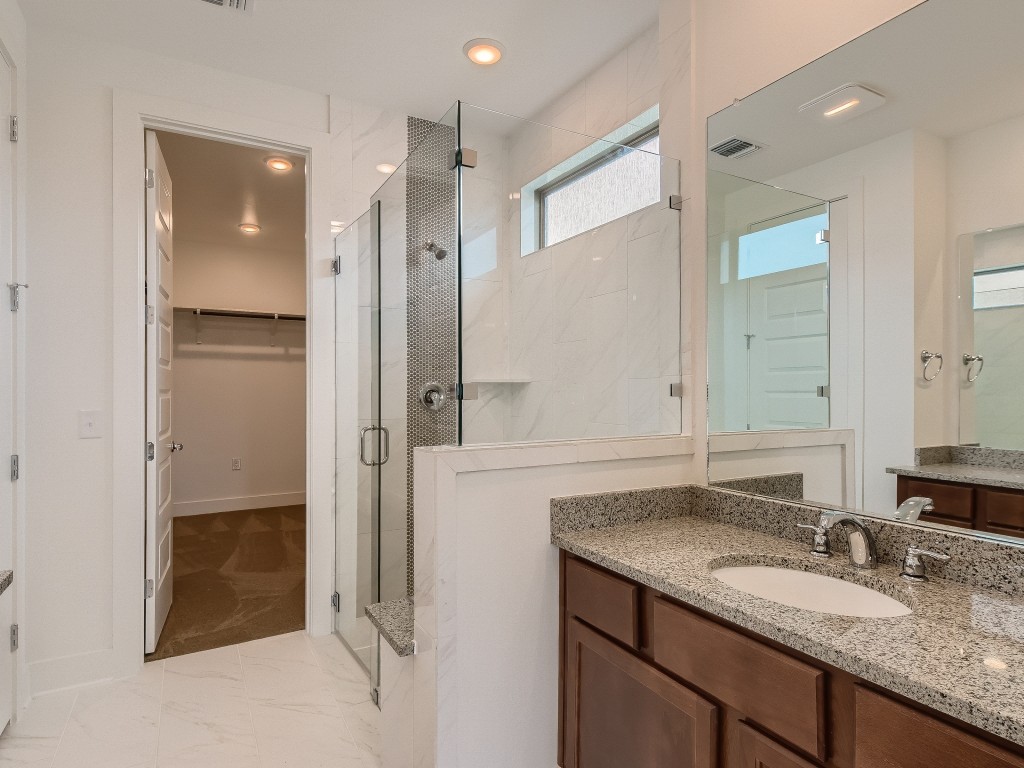 9101 Spire View Austin, TX 78744 - Photo 18 of 29 a bathroom with a granite countertop sink and a mirror