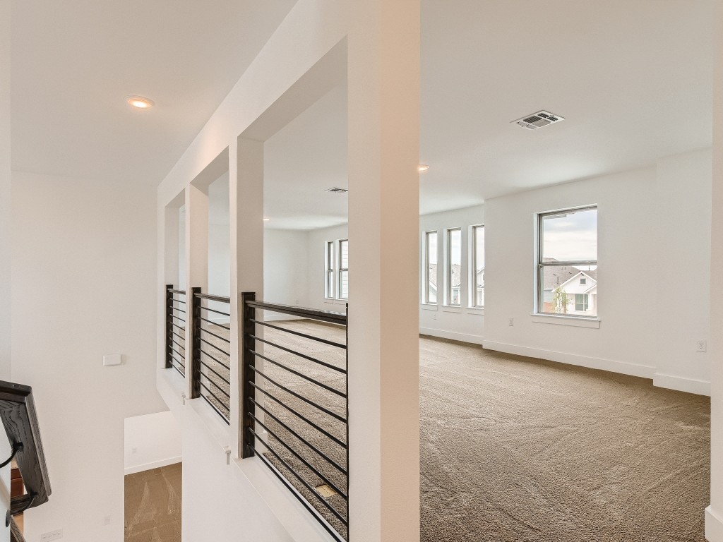9101 Spire View Austin, TX 78744 - Photo 25 of 29 a view of a hallway with entryway and stairs