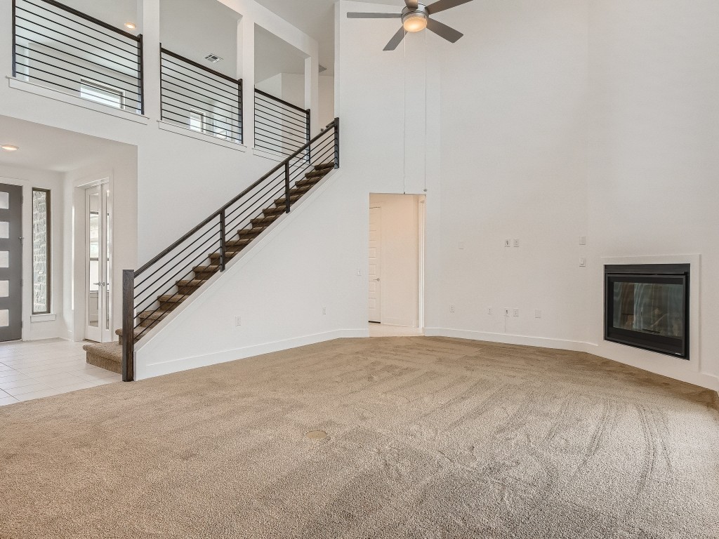9101 Spire View Austin, TX 78744 - Photo 6 of 29 a view of an empty room with stairs and a ceiling fan