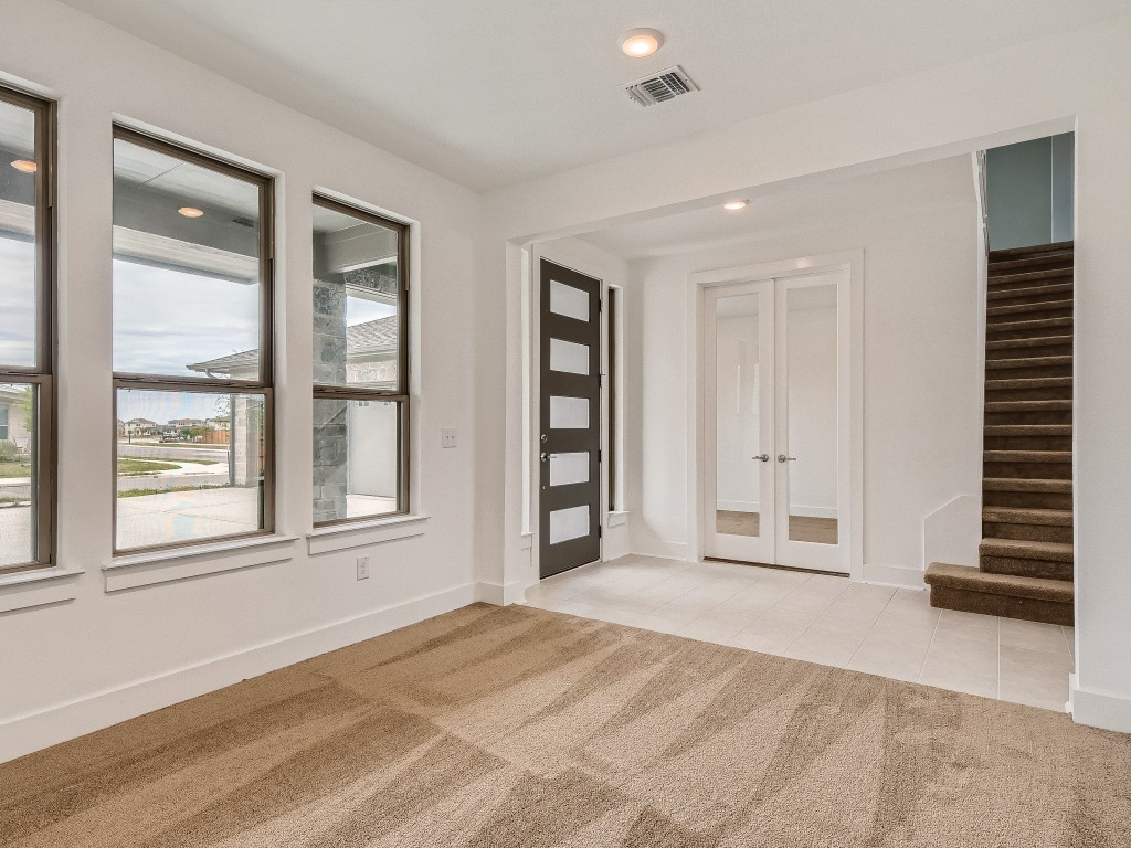 9101 Spire View Austin, TX 78744 - Photo 7 of 29 a view of an empty room with a window and stairs