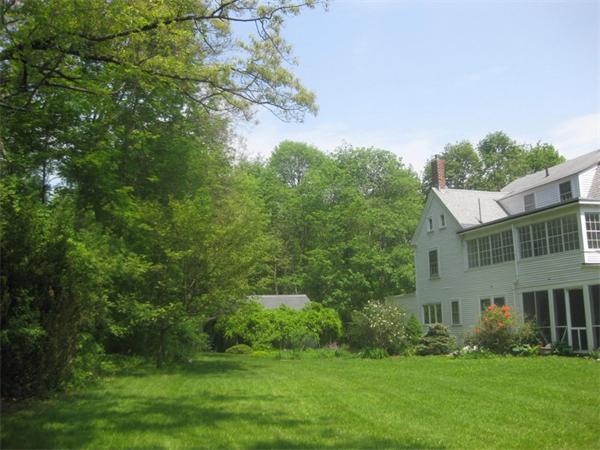144 Nashoba Road Concord, MA 01742 - Photo 4 of 10 a view of a garden with plants and large trees