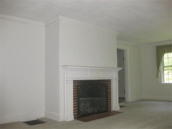 144 Nashoba Road Concord, MA 01742 - Photo 7 of 10 a living room with a fireplace in it